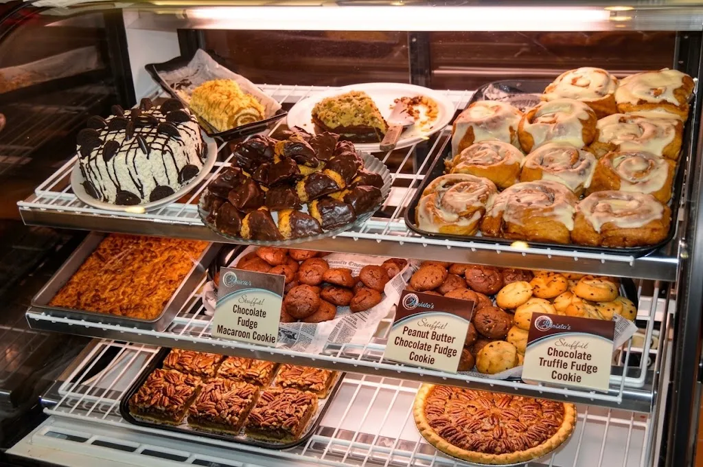The bakery case stocked with Mrs. Mary's cakes, cookies and baklava