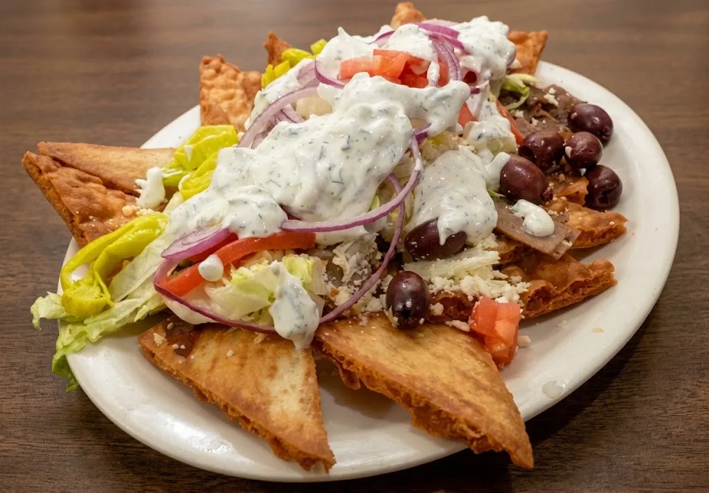 Fried pita chips piled with tzatziki, tomato, red onion, Kalamata olives and pepperoncini