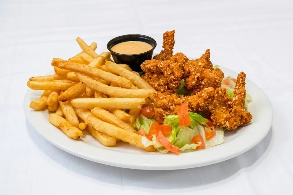 Crispy breaded shrimp with fries, a side salad and a cup of dipping sauce