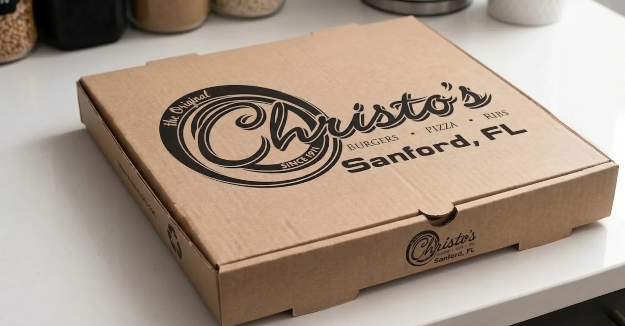 A Christo's to-go pizza box, Sanford FL stamped on the lid